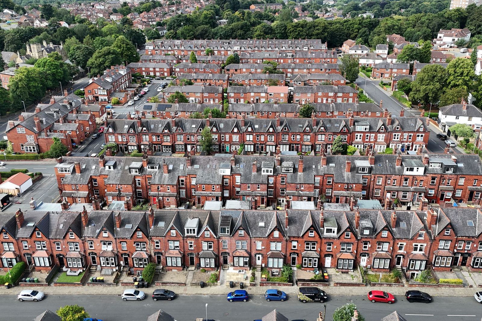 Aerial view of long rows of red brick terraced houses with grey slate roofs and bay windows