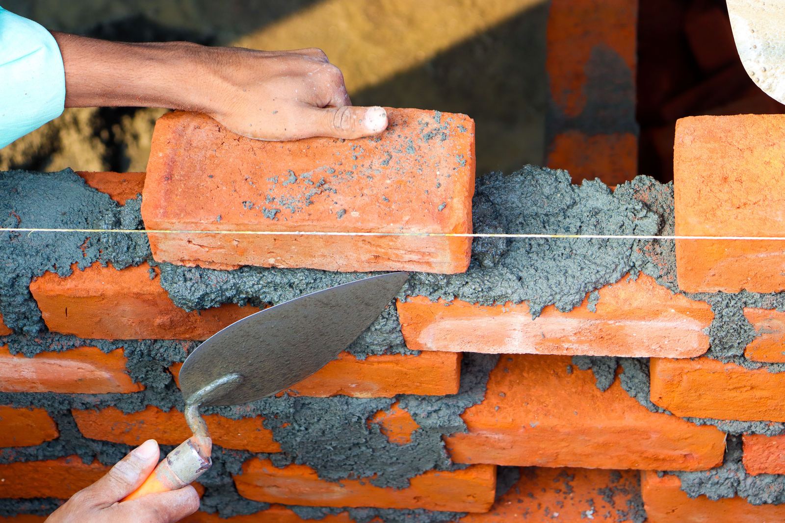 Raked-out mortar joints on a brick wall, cut back ready for new mortar