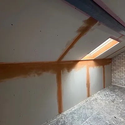 Loft room lined and taped between and under the rafters with a rooflight above