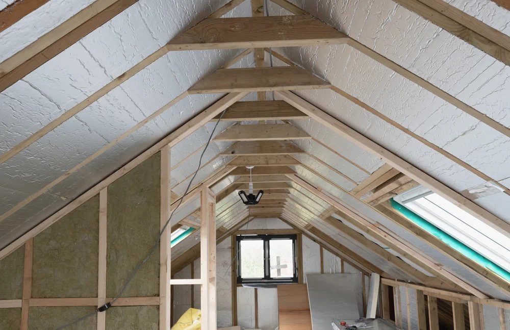 Loft conversion insulated with foil faced boards and mineral wool around a rooflight