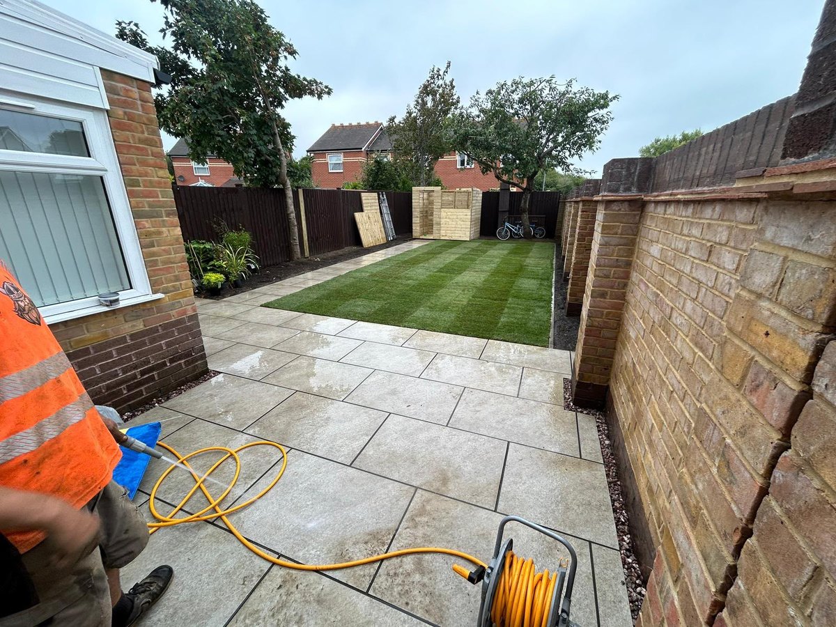 A porcelain patio laid out in courses with the joints brushed in