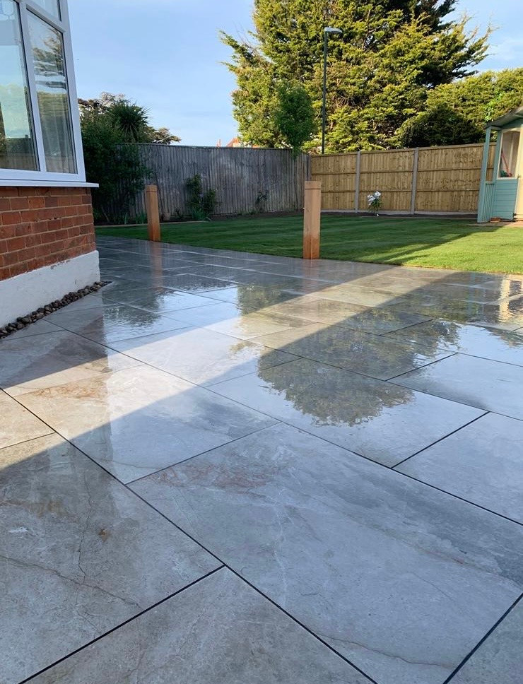 Wet porcelain paving showing where the water runs and where it stands