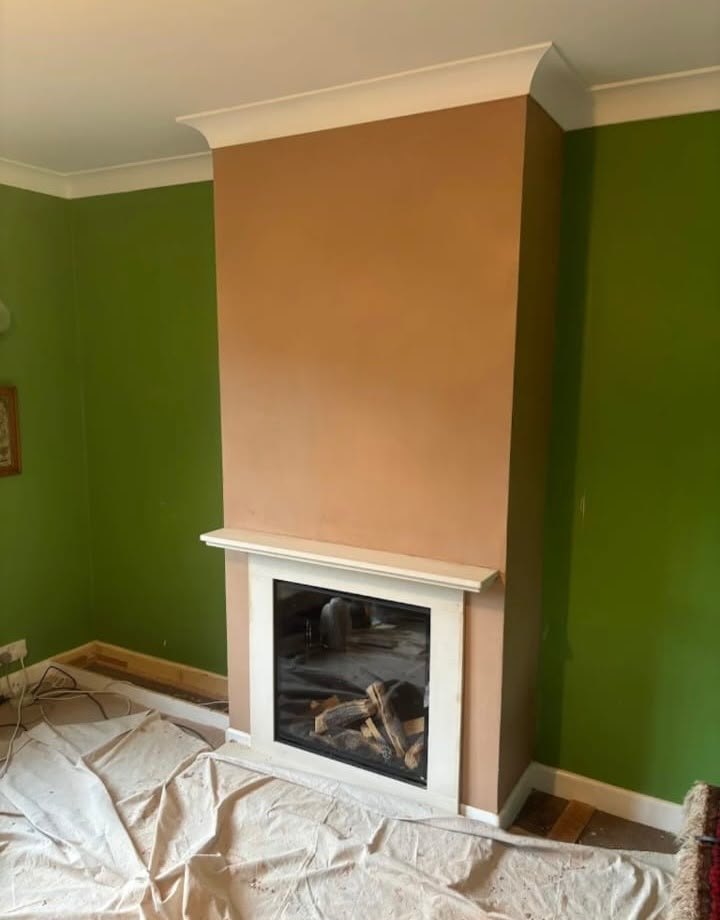 Chimney breast freshly plastered above a fireplace, dried out and ready for decorating