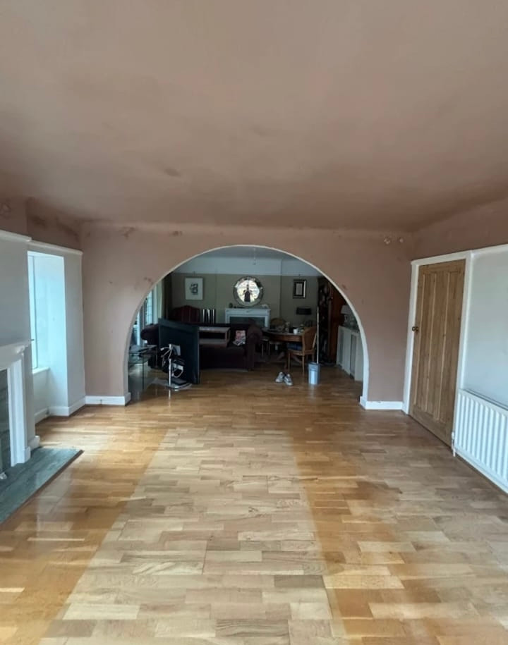 Freshly plastered lounge with a formed archway, walls and ceiling skimmed and drying